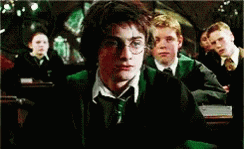 Harry Potter Is Sitting In A Classroom With Other Students GIF