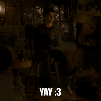 Harry Potter Is Sitting On A Stool In A Dark Room With The Words Yay : 3 Below Him GIF