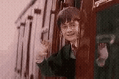 Harry Potter Is Waving While Riding A Train . GIF