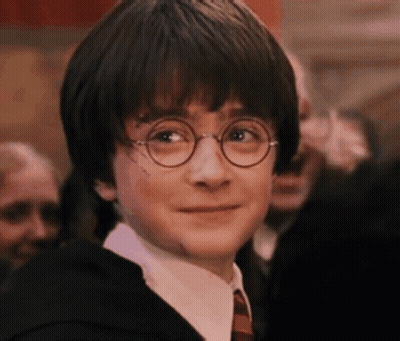 Harry Potter Wearing Glasses And A Suit And Tie Is Smiling . GIF