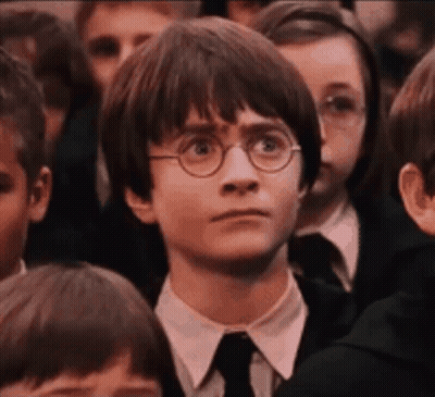 Harry Potter Wearing Glasses And A Tie Is Sitting In A Crowd Of Children . GIF