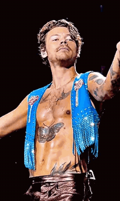 Harry Styles Blue Vest With Fringe And Chest Tattoo GIF