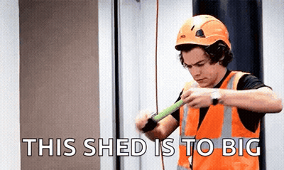 Harry Styles In Hard Hat And Safety Vest Measuring Wood GIF