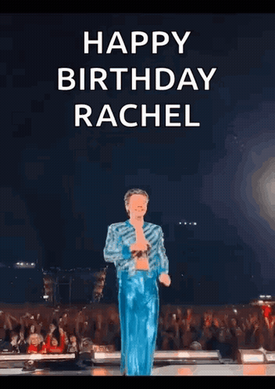 harry styles is standing on a stage with his arms outstretched .