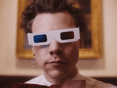 Harry Styles Is Wearing A Pair Of 3D Glasses In Front Of A Painting . GIF