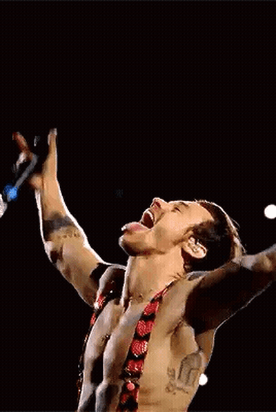 Harry Styles Singing Into Microphone Shirtless On Stage GIF