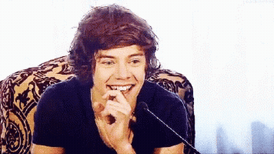 Harry Styles Smiling In Chair GIF
