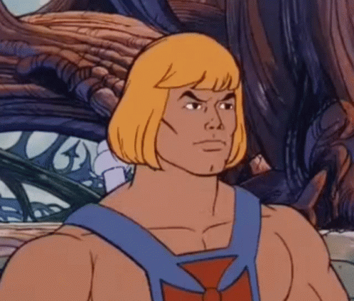 He Man From Masters Of The Universe Is A Cartoon Character With Blonde Hair And A Blue Vest . GIF