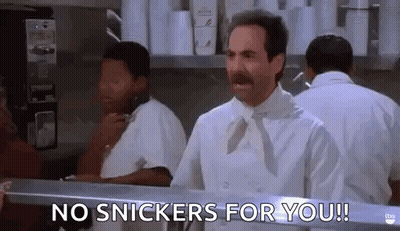 Heart Shaped Mirror Reflecting Snickers Bar Being Eaten GIF