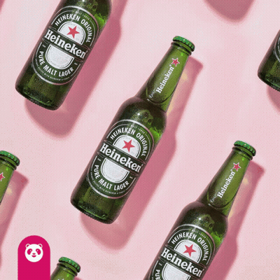 Heineken Bottles Lined Up On Pink Surface GIF
