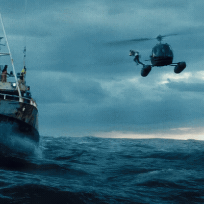 Helicopter Hovering Over Boat In Ocean GIF