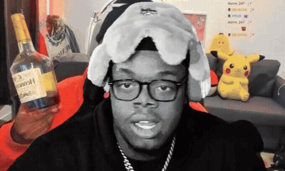 Hennessy Bottle On Couch Beside Man With Glasses GIF