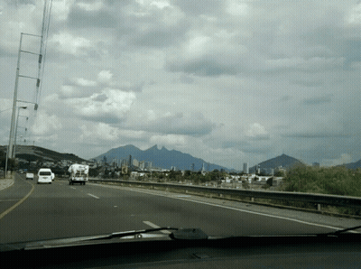 Highway With Mountains And City GIF