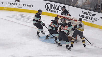 Hockey Game In Front Of America First Credit Union Banner GIF