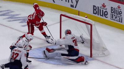 Hockey Game In Front Of Blue Light Banner GIF