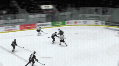 Hockey Game In Front Of Blue Light Banner GIF
