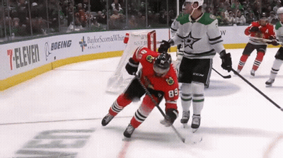 Hockey Game In Front Of Boeing And 7-Eleven Ads GIF