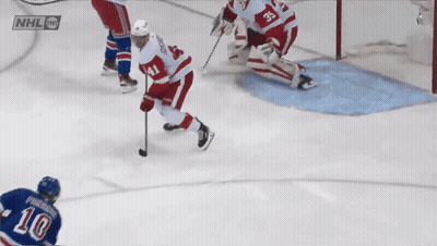 Hockey Game In Front Of Chase And Spectra Ads GIF