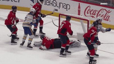 Hockey Game In Front Of Coca Cola Sign GIF