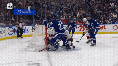 Hockey Game In Front Of Esso Banner GIF