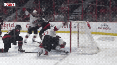 Hockey Game In Front Of Gabriel Pizza Ad GIF