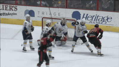 Hockey Game In Front Of Heritage Bank Ads GIF