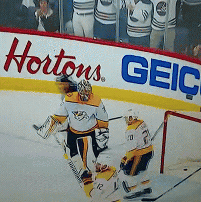Hockey Game In Front Of Hortons Geico Sign GIF