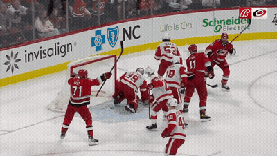 Hockey Game In Front Of Invisalign Banner GIF