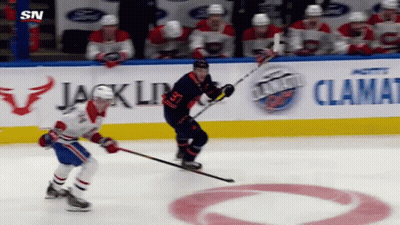 Hockey Game In Front Of Jack Link Sign GIF