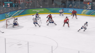 Hockey Game In Front Of Milano Cortina Sign GIF