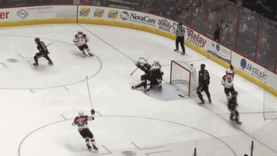Hockey Game In Front Of Novacare Advertisement GIF
