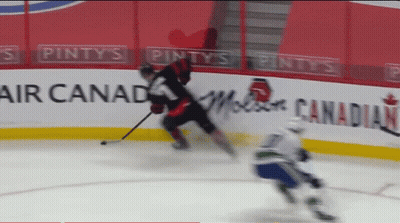 Hockey Game In Front Of Pinty's Air Canada Banner GIF