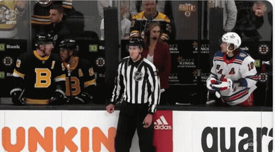 Hockey Game In Front Of Unkin Quartz Sign GIF
