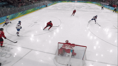 Hockey Game On Rink With Olympic Rings GIF