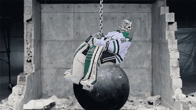 Hockey Goalie Hanging From Wrecking Ball Chain GIF