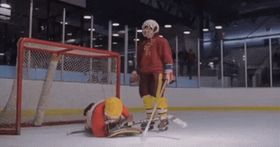 Hockey Goalie Standing Next To Fallen Player GIF