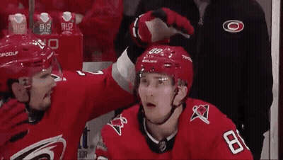 Hockey Player 18 Next To Another Player GIF