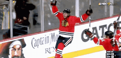 Hockey Player Celebrates Goal In Front Of Captain Morgan Ad GIF