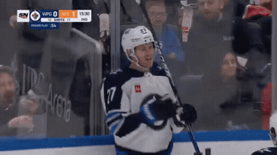 Hockey Player Holding Stick In Front Of Crowd GIF