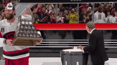 Hockey Player Holding Trophy With SN On Hat GIF