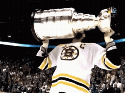 Hockey Player In B Jersey Holding Trophy Over Head GIF