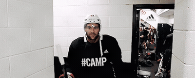 Hockey Player In Black Camp Shirt In Hallway GIF