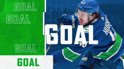 Hockey Player In Blue And Green Jersey With Goal GIF