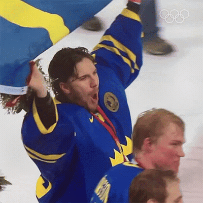 Hockey Player In Blue And Yellow Jersey Holding Flag GIF