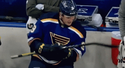 Hockey Player In Blue Jersey Holding Stick GIF