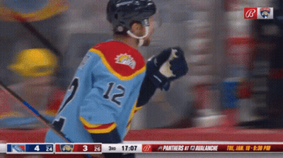 Hockey Player In Blue Jersey Number 12 GIF