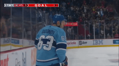 Hockey Player In Blue Jersey With Number 63 GIF