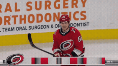 Hockey Player In Front Of Oral Surgery Ad GIF