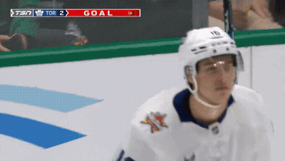 Hockey Player in Front of Scoreboard Saying Tor 2 Goal