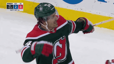 Hockey Player In Green And Red Jersey Holding Stick GIF